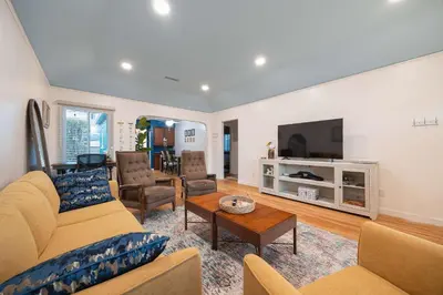 a living room with a couch and a tv at 10 Min to the Beach Colorful Home Huge Yard in San Diego