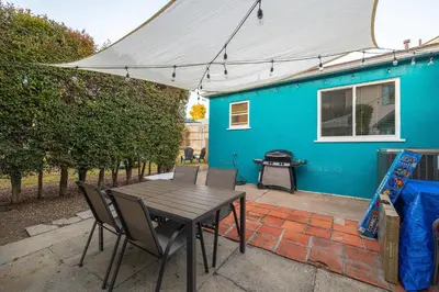 a blue house with a table and chairs in front of it at 10 Min to the Beach Colorful Home Huge Yard in San Diego