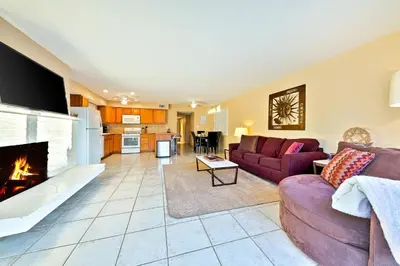 a living room with a couch and a fireplace at Newport Beach Simplicity in Newport Beach
