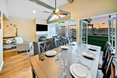 a dining room with a table and chairs at Perfect Newport Beach Location With Balcony Spa II in Newport Beach