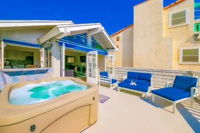 a hot tub on the patio of a house at Perfect Newport Beach Location With Balcony Spa II in Newport Beach