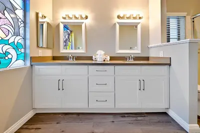 a white bathroom with two sinks and mirrors at Perfect Newport Beach Location With Balcony Spa II in Newport Beach