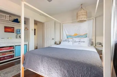 a bedroom with a large bed with a canopy at Cozy Room with Hot Tub, Pool, Sauna & Gym Near Beach in Oceanside