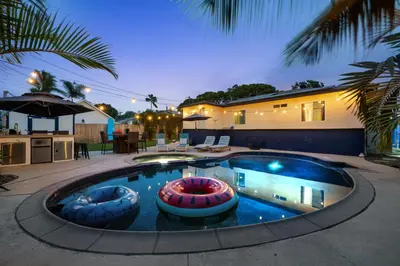 a swimming pool with two inflatable balls in it at Cozy Room with Hot Tub, Pool, Sauna & Gym Near Beach in Oceanside