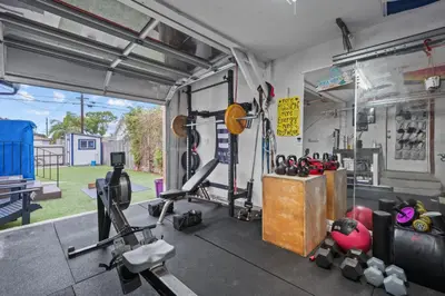 a garage with a gym with equipment in it at Cozy Room with Hot Tub, Pool, Sauna & Gym Near Beach in Oceanside