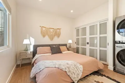 a bedroom with a bed and two lamps and a window at Urban Villa in San Diego