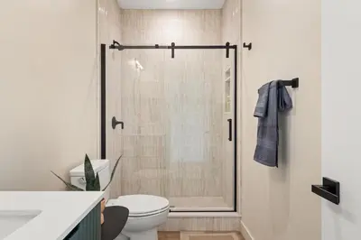 a bathroom with a shower with a toilet and a sink at Urban Villa in San Diego