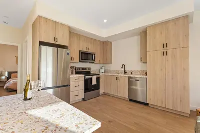 a kitchen with wooden cabinets and stainless steel appliances at Urban Villa in San Diego