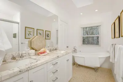 a white bathroom with a tub and a sink at Seaview craftsman with Amazing views in San Diego