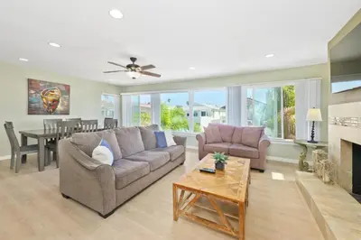 a living room with a couch and a dining room at Salt & Sand II in Newport Beach