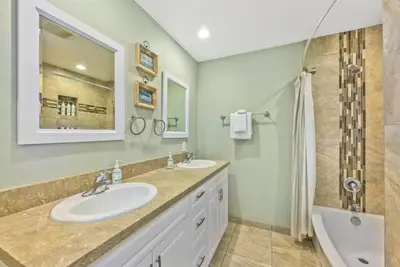 a bathroom with two sinks and a shower at Salt & Sand II in Newport Beach