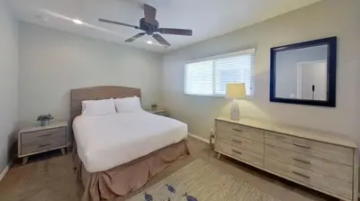 a bedroom with a bed and a ceiling fan at Salt & Sand I in Newport Beach