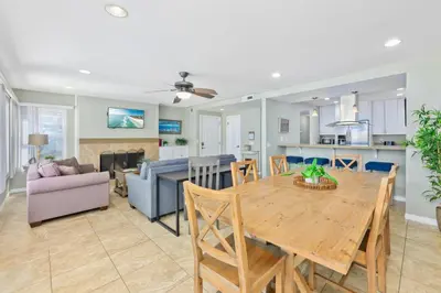 a dining room and living room with a wooden table at Salt & Sand I in Newport Beach