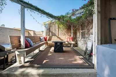 a patio with a bench and a table at Heart of La Jolla Village cottage in San Diego