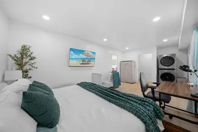 a bedroom with a bed with a green blanket on it at Entire Private Home with 2 Bedrooms 1 Bathroom, Grand View, King Bed, Spacious, Parking, Available Now in El Cajon