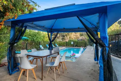 a blue tent with a table and chairs next to a pool at Entire Private Home with 2 Bedrooms 1 Bathroom, Grand View, King Bed, Spacious, Parking, Available Now in El Cajon