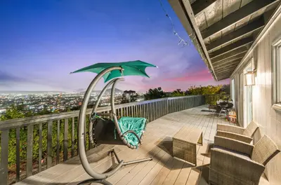 a patio with a green umbrella on a deck at Entire Private Home with 2 Bedrooms 1 Bathroom, Grand View, King Bed, Spacious, Parking, Available Now in El Cajon