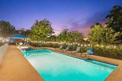 a swimming pool with chairs and lights on a fence at Entire Private Home with 2 Bedrooms 1 Bathroom, Grand View, King Bed, Spacious, Parking, Available Now in El Cajon