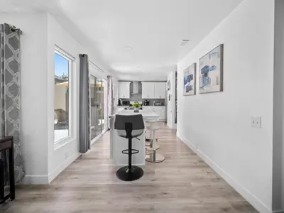 a white hallway with a stool in the middle of a room at Recently updated home close to La Jolla & Del Mar- 2 bedrooms home in San Diego