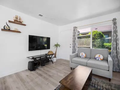 a living room with a couch and a tv at Recently updated home close to La Jolla & Del Mar- 2 bedrooms home in San Diego