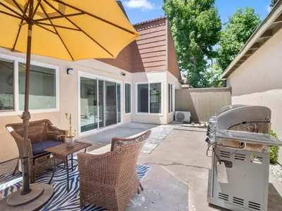 a patio with a yellow umbrella and a grill at Recently updated home close to La Jolla & Del Mar- 2 bedrooms home in San Diego