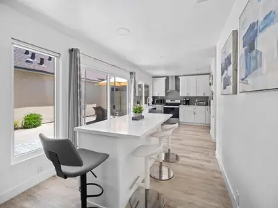 a kitchen with a white counter and some chairs at Recently updated home close to La Jolla & Del Mar- 2 bedrooms home in San Diego