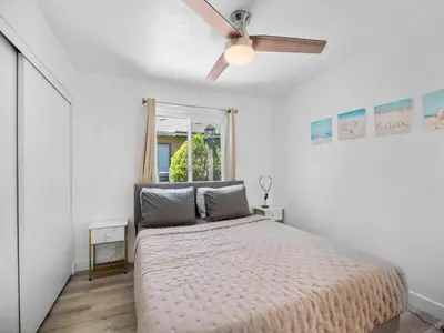 a bedroom with a bed with a ceiling fan at Recently updated home close to La Jolla & Del Mar- 2 bedrooms home in San Diego