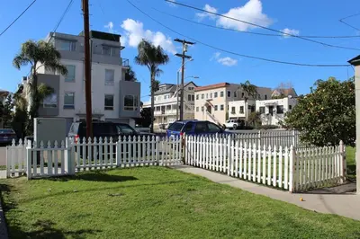 a white picket fence in front of a yard at Cozy Urban Cottage in San Diego