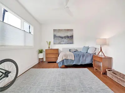 a bedroom with a bed and a dresser and a window at Lovely Laguna Oceanside Gem! in Laguna Beach