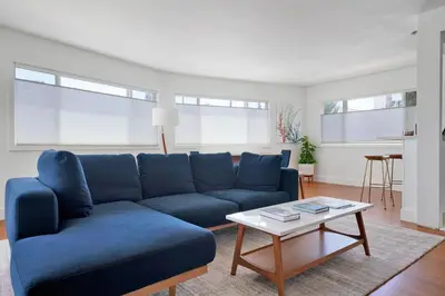 a living room with a blue couch and a coffee table at Lovely Laguna Oceanside Gem! in Laguna Beach