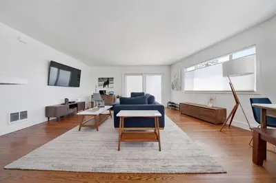 a living room with a blue couch and a table at Lovely Laguna Oceanside Gem! in Laguna Beach