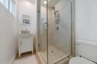 a bathroom with a shower and a toilet and a sink at Lovely Laguna Oceanside Gem! in Laguna Beach