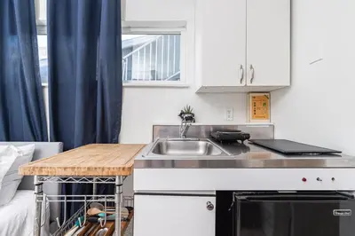 a small kitchen with a sink and a counter at 4Br Retreat One House From The Beach And Boardwalk By Beachview Rentals in Newport Beach