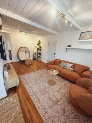 a living room with a couch and a rug at Modern Eclectic 2BR Near Petco, Balboa Park & Zoo in San Diego
