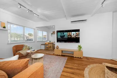 a living room with a couch and a flat screen tv at Modern Eclectic 2BR Near Petco, Balboa Park & Zoo in San Diego