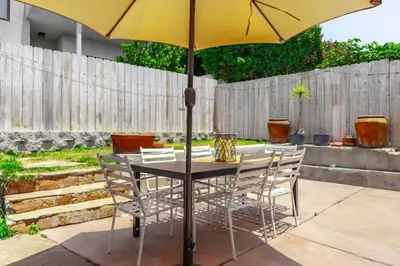 a table with chairs and an umbrella on a patio at 2BR-2 mins to Ocean-Sleeps 8-Pets in San Diego