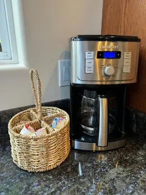 a coffee maker and a basket on a counter at Windansea Hideaway Rooftop Ocean Views in San Diego