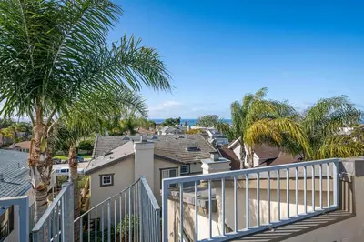 a balcony of a house with palm trees at Windansea Hideaway Rooftop Ocean Views in San Diego