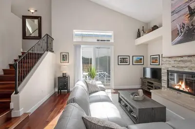 a living room with a couch and a fireplace at Windansea Hideaway Rooftop Ocean Views in San Diego