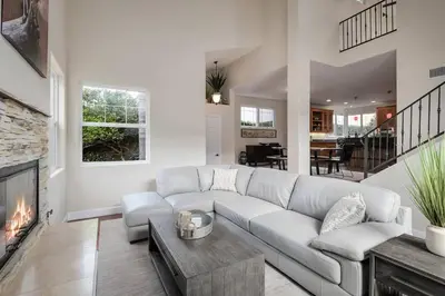 a living room with a couch and a fireplace at Windansea Hideaway Rooftop Ocean Views in San Diego