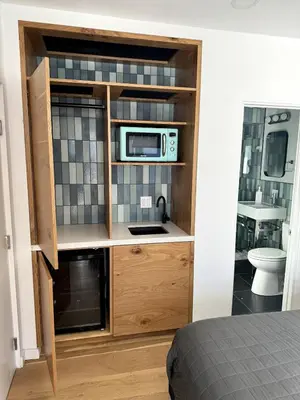 a microwave in a cabinet in a bedroom at Simple La Jolla Epic bungalow # 3 in San Diego