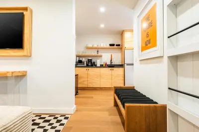 a living room with a couch and a tv at Simple La Jolla 2 bedroom - Alley Unit in San Diego