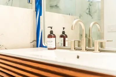 a bottle of soap sitting on a bathroom sink at Simple La Jolla 2 bedroom - Alley Unit in San Diego