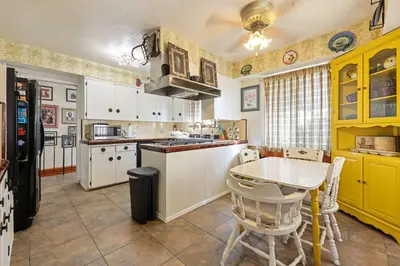 a kitchen with yellow cabinets and a table in it at A Visit to Grandma's House in San Diego