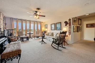 a living room with a couch and a ceiling fan at Stay at Grandmas Entire Home with Yard & Balcony in San Diego