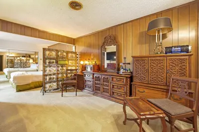 a bedroom with wooden walls and a bed with a mirror at Stay at Grandmas Entire Home with Yard & Balcony in San Diego