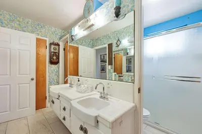 a bathroom with a sink and a mirror at Stay at Grandmas Entire Home with Yard & Balcony in San Diego
