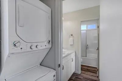 a white bathroom with a sink and a mirror at Walk to Ocean Beach Stylish 2BR Apt with Patio in San Diego