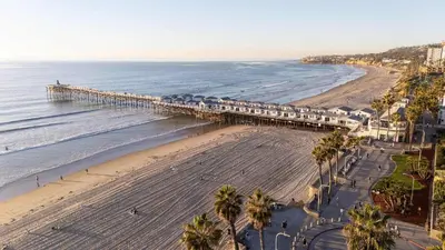 an aerial view of a beach with a pier at Steps tp beach Prime location Villa in San Diego