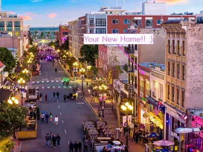 a city street with a sign that reads your new home at Gaslamp 2BR Upscale Queen Beds with Smart TV in San Diego